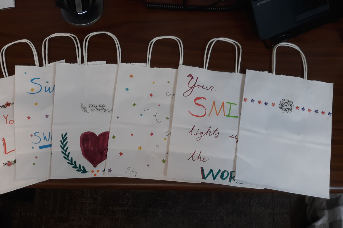 Gift bag shaped holiday cards from Twin Cities Pain Clinic staff