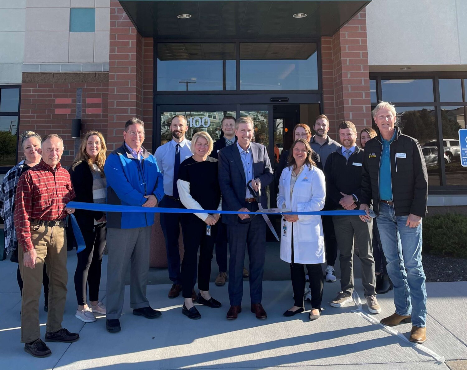 Pain clinic team and chamber representatives pose for the ribbon cutting at Twin Cities Pain Clinic in Maplewood, MN