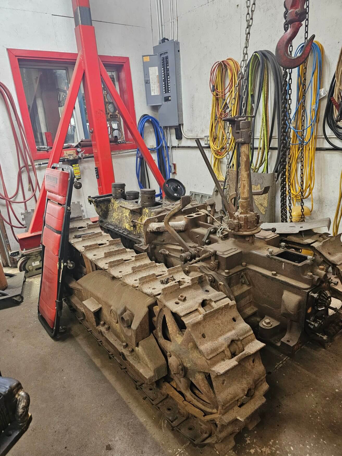 Stripped down pieces of a 1927 Caterpillar two-ton tractor in a machine shop