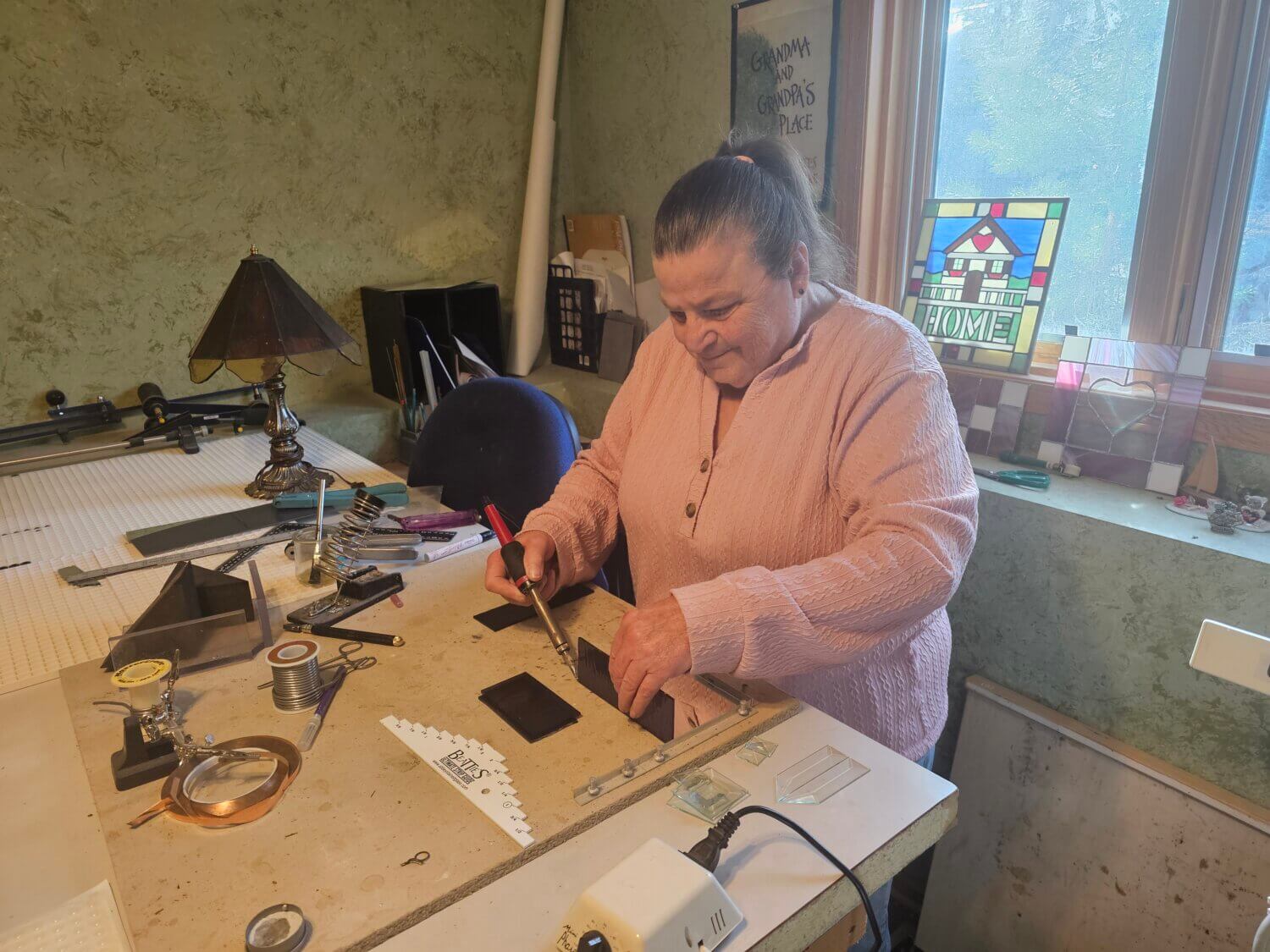 Cheri Haberle at a work bench doing a project with tools