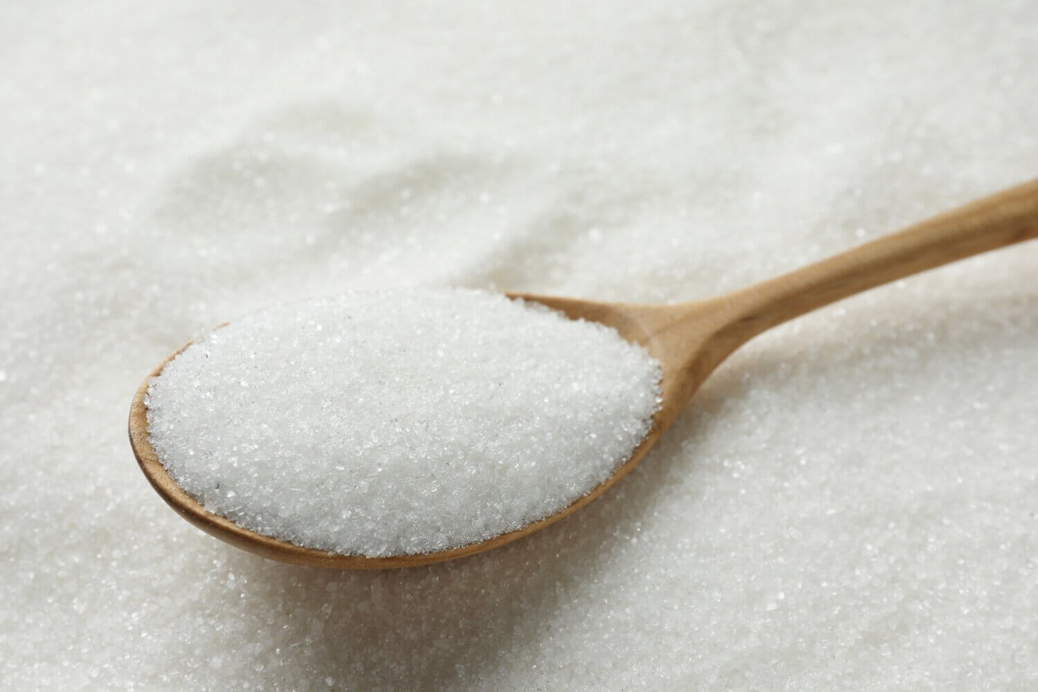 Wooden spoon full of sugar