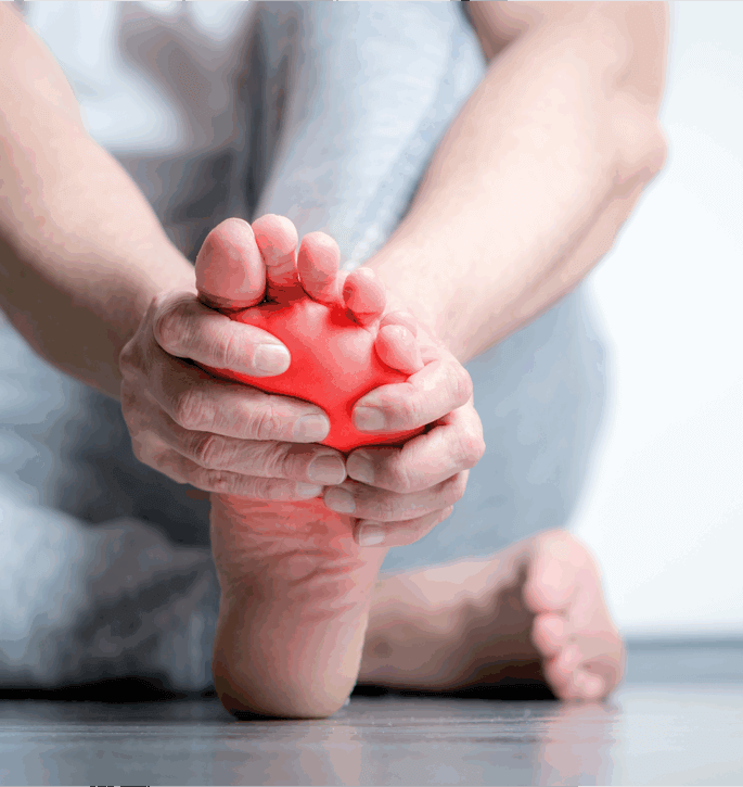 Close up of a person with foot pain holding their glowing red foot