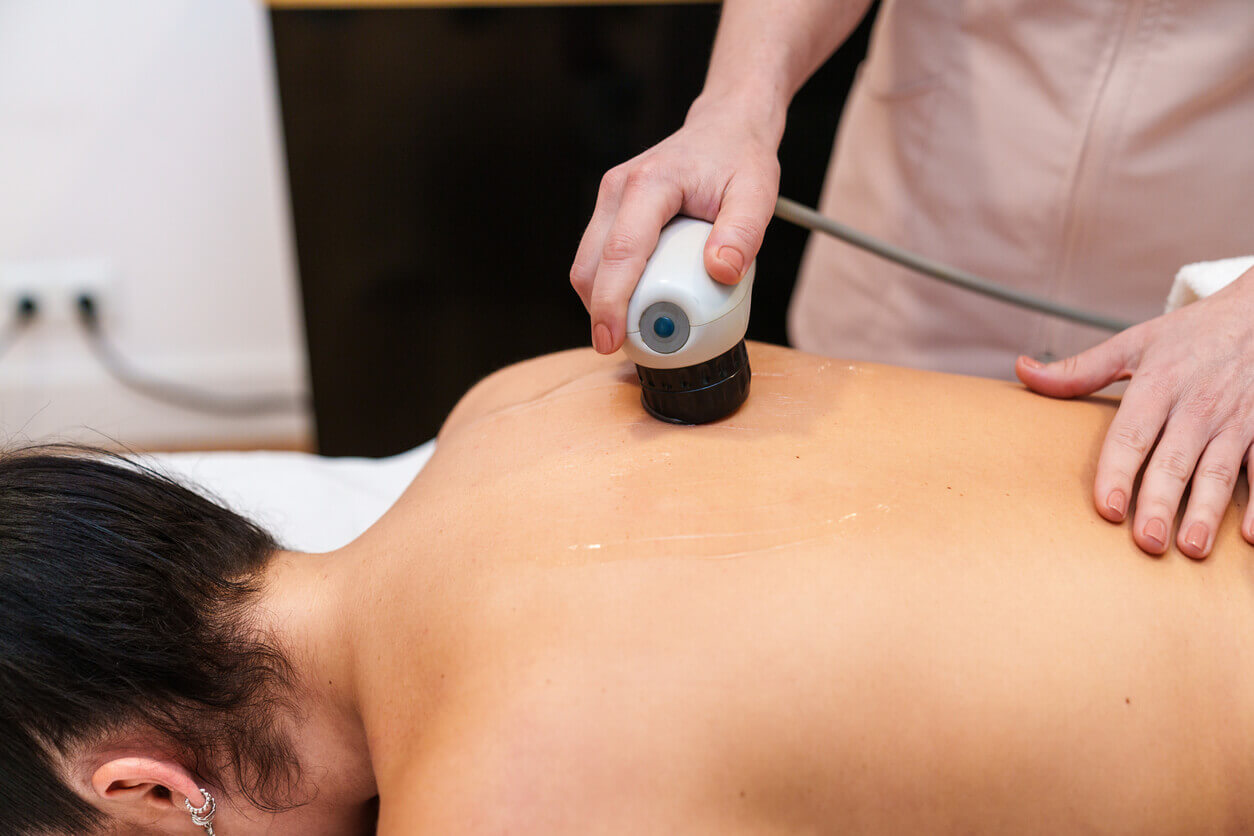 Pain management specialist administers radio frequency treatment for back pain on Patient.